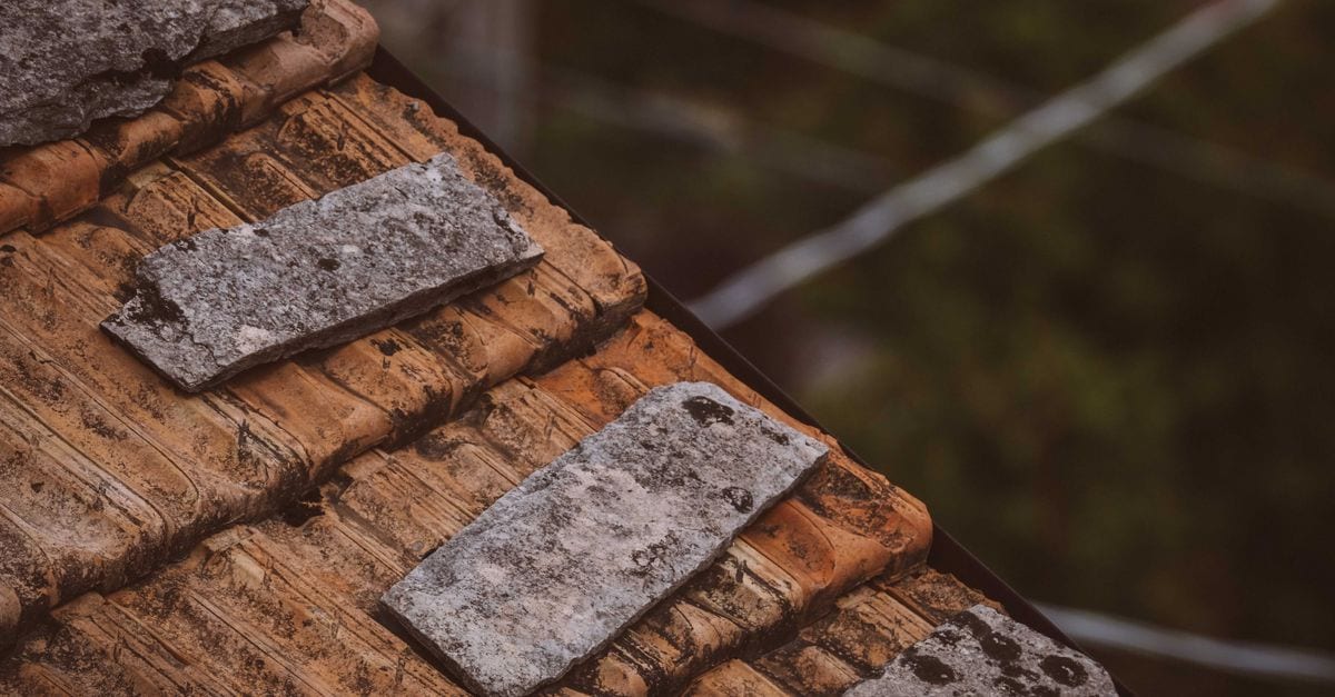 Concrete tile roof with algae staining treated and cleaned